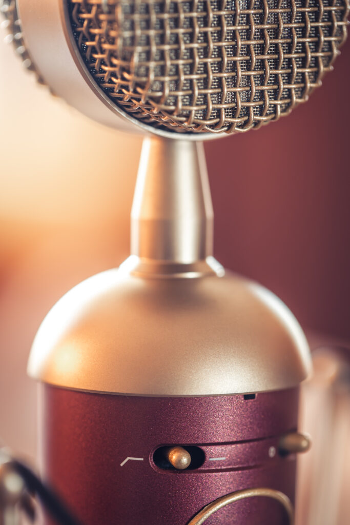 Close-up of a vintage-style microphone with a warm background.